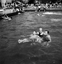 German men and women having fun in a swimming pool