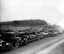 Automobiles parked in field