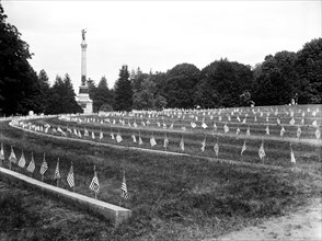 American flags on graves at cemetery