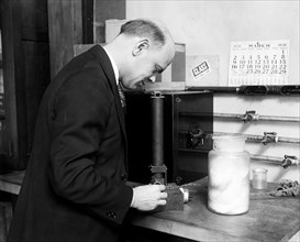 H.J. McNicholas of the Textile Section is shown with his invention