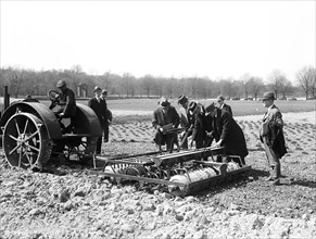 Group in field with farm machinery