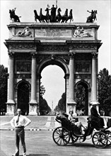 Tourist standing in front of the Arco della Pace in Milan Italy
