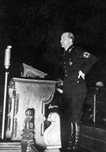 Nazi officer standing at what appears to be a church lectern