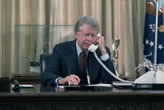 Jimmy Carter on the telephone in the oval office