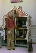 Amy Carter poses with her doll house and cat Misty Malarky Ying Yang