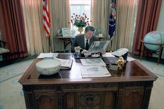 President Reagan eating lunch at his desk in the oval office