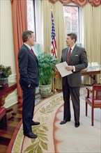 President Reagan talking with Vice President Bush.