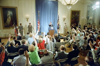 President Reagan listening to questions during a press conference.