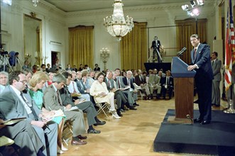 President Reagan listening to questions during a press conference.