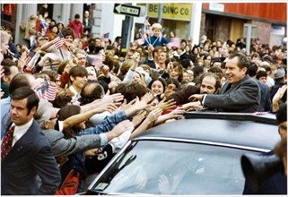 President Richard Nixon Smiles as Members of the Crowd Reach out
