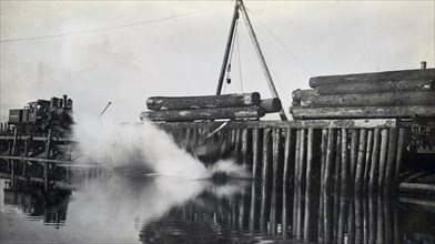 Unloading logs boom in British Columbia, Canada ca. 1918