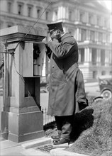Man using the call box at the White House ca. 1910