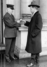 Employee examining a pass at State Department ca. 1913