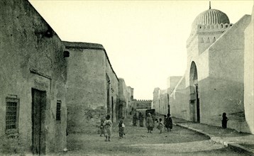 Kids in street outside of Great Mosque of Kairouan ca. 1900