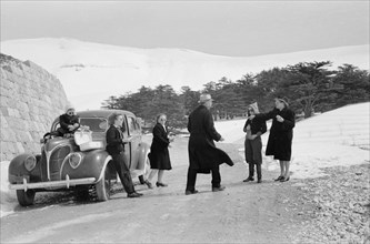 Photographic party stops for a cold snowy lunch ca. 1946