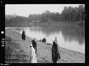 Iraq. River scenes on the Euphrates taken at Hilla. Women carrying water from the river ca. 1932