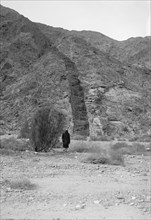 Man walking the Diorite dyke in Wady Es-Slaf. ca. 1900