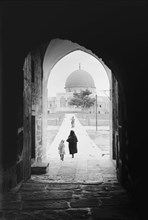 Temple area, Mosque of Omar [i.e., Dome of the Rock], etc. Mosque of Omar from the north, woman and daughter walking to the mosque. ca. 1900
