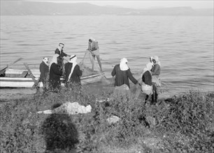 Arab fishermen working on their net on the east side of the Sea of Galilee ca. between 1934 and 1939