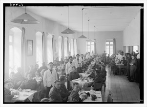 Service men and wait staff or watiers in the dining hall at YMCA hostel (old post office) ca. between 1940 and 1946