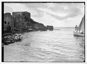 Sunset scene with man on fishing boat (castle on left, silhouetted) in Caesarea (Kaisarieh)  ca. 1938