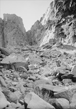 Man walking on the rocks of the ascent to Ras Safsaf by Jethro's Path. ca. 1900