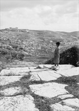 Excavations on the grounds of the Assumptionists in Jerusalem, old stairway, looking east, showing Siloam, boy standing at top of stairs ca. 1900
