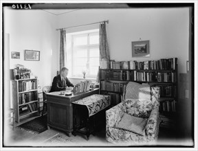Dr. MacLean or Dr. McLean in his study in his house ca. between 1940 and 1946
