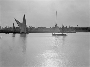 Scene along the Cairo banks of the Nile River, many sailboats on the river  ca. between 1934 and 1939
