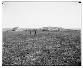 East of Jordan and the Dead Sea. General view of Madeba (or Madaba Jordan), men walking in a field ca. between 1898 and 1914