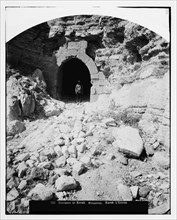Man standing in the tunnelled entrance to Kerak ca. between 1898 and 1914