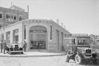 New Buick automobile and GMC bus outside the Buick agency (Buick Dealership) in Israel ca. between 1920 and 1935