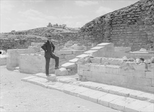 Man standing next to a section of the temple excavations in Sakkara Egypt (Saqqara) ca. between 1934 and 1939