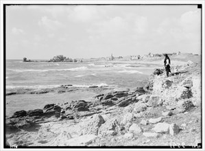 Man standing on shore looking out at the seat in Caesarea (Kaisarieh) ca. 1938