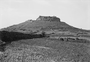 Man plowing a field in front of castle hill near Salkhad Syria ca. 1938