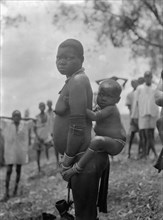 1930s Uganda Woman carrying child ca. 1936