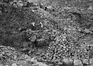 Women carrying water jars in Kanawat among Roman runways for water mills ca. 1938