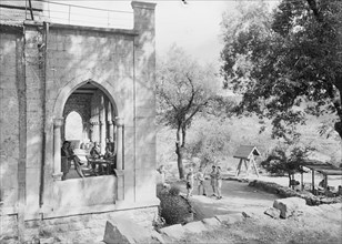 Men and women enjoying a time of relaxing at the Chouer Mountain House, view of the main building ca. 1945
