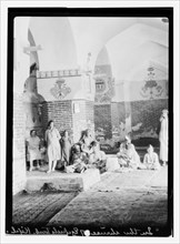 Men, women and children in the shrine of Ezekiel's Tomb in Kifel ca. 1932