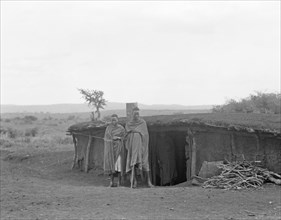 Semi subterranean dwellers, (man and woman?) living in Namanga Kenya, on the game reserve ca. 1936