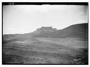 A distant view from the northeast of Krak des Chevaliers and the St. George Monastery ca. 1936