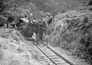 Soldiers get a close up view of a wrecked train engine near Deir esh-Sheikh ca. between 1934 and 1939