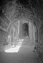 House of Veronica on Via Dolorosa 6th station of the Cross, people walking down the street ca. between 1940 and 1946