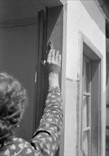 A Yemenite youth touching the  Mazuza when passing through the doorway ca. between 1934 and 1939