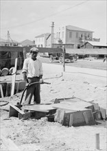 A man building a home in Tel Aviv, beginning with the concrete foundations ca. 1920