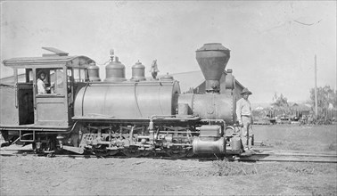 Two men on a locomotive engine in Hawaii ca.  between 1910 and 1920
