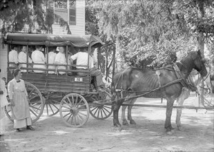 A horse pulling a wagon of people at Camp Goodwill ca.  between 1910 and 1920