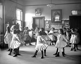 Young girls dancing in a classroom in Georgetown, D.C. ca.  between 1910 and 1920