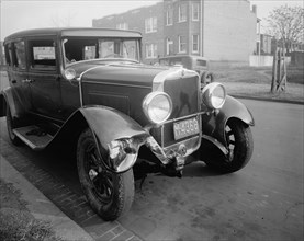 Close up of a car involved in an auto accident, a fender bender ca. between 1910 and 1935
