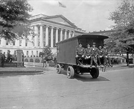 Police officers on the back of a truck, going to the Bureau of Printing & Engraving, [Washington, D.C.] ca.  between 1910 and 1925